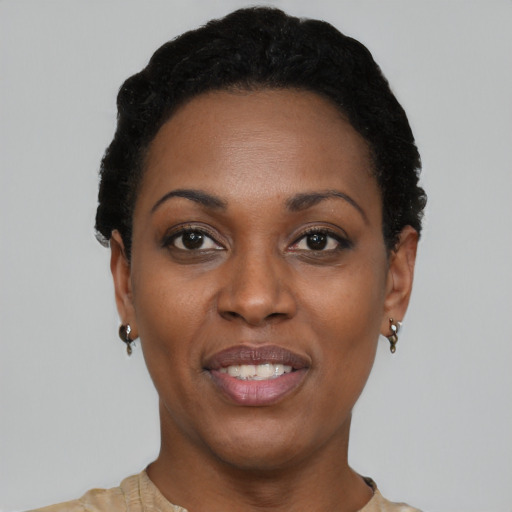 Joyful black young-adult female with short  black hair and brown eyes