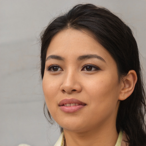 Joyful asian young-adult female with long  brown hair and brown eyes