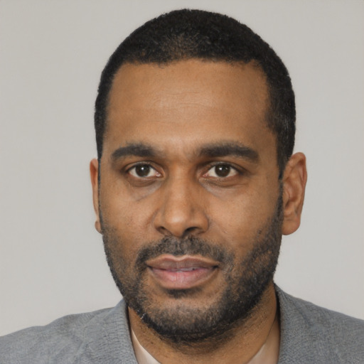 Neutral black adult male with short  black hair and brown eyes