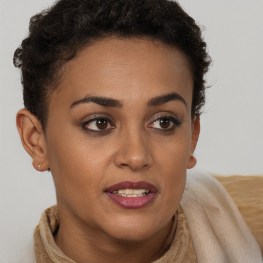 Joyful black young-adult female with short  brown hair and brown eyes