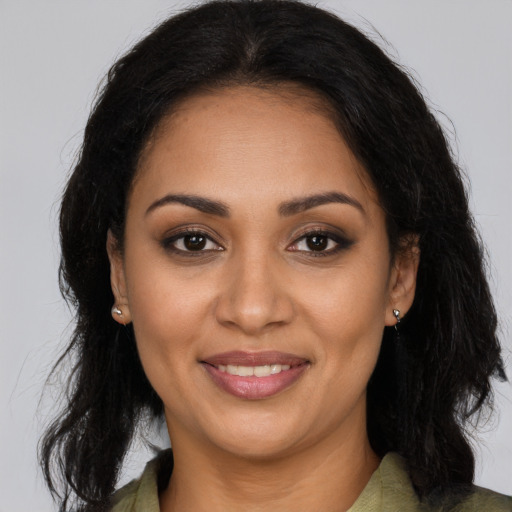 Joyful latino young-adult female with long  brown hair and brown eyes