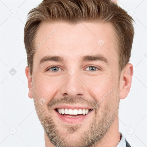 Joyful white young-adult male with short  brown hair and grey eyes