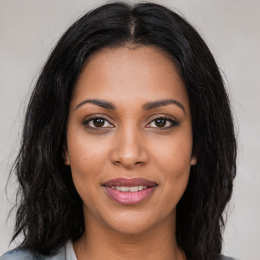 Joyful latino young-adult female with long  black hair and brown eyes