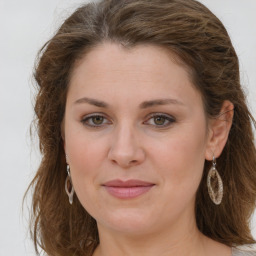 Joyful white young-adult female with long  brown hair and green eyes