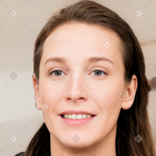 Joyful white young-adult female with long  brown hair and grey eyes