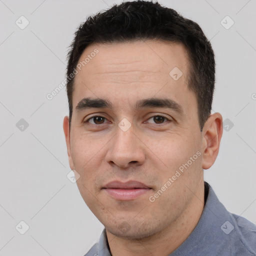 Joyful white young-adult male with short  black hair and brown eyes