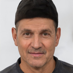 Joyful white adult male with short  black hair and brown eyes