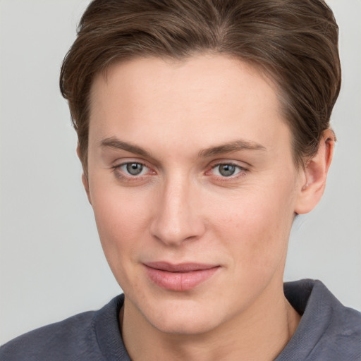 Joyful white young-adult female with short  brown hair and grey eyes