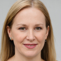 Joyful white adult female with long  brown hair and grey eyes