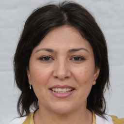 Joyful white adult female with medium  brown hair and brown eyes