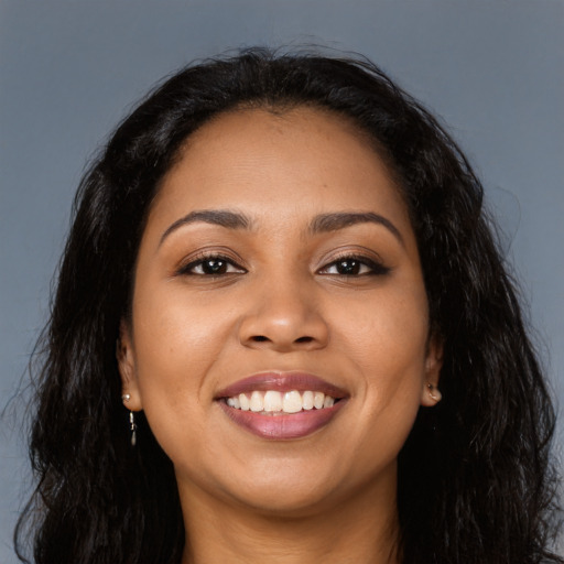 Joyful latino young-adult female with long  black hair and brown eyes