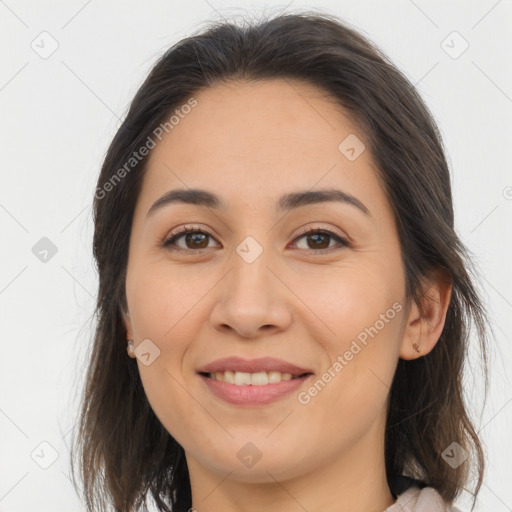 Joyful white young-adult female with long  brown hair and brown eyes