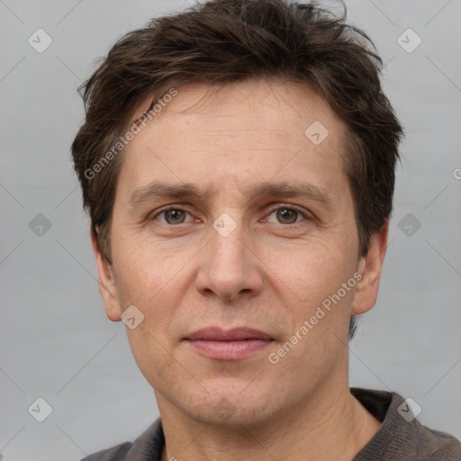 Joyful white adult male with short  brown hair and grey eyes