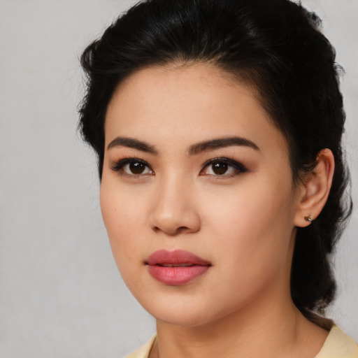 Joyful asian young-adult female with medium  black hair and brown eyes