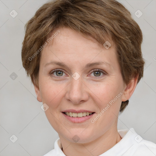 Joyful white adult female with short  brown hair and grey eyes