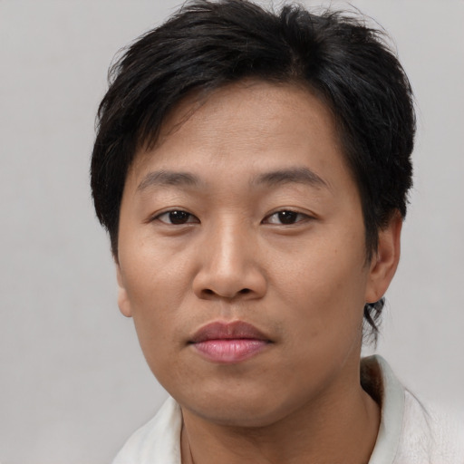 Neutral asian adult female with short  brown hair and brown eyes