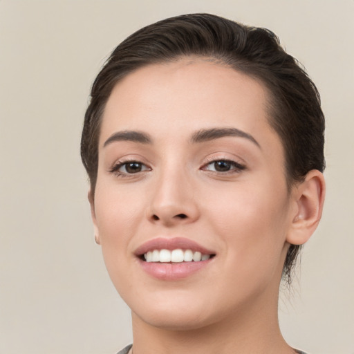 Joyful white young-adult female with short  brown hair and brown eyes