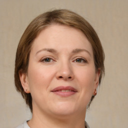 Joyful white adult female with medium  brown hair and brown eyes