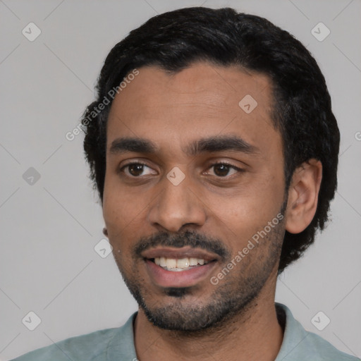 Joyful latino young-adult male with short  black hair and brown eyes