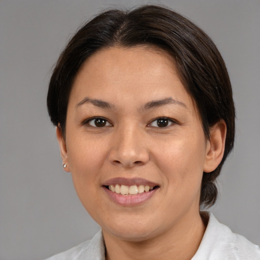 Joyful asian young-adult female with medium  brown hair and brown eyes