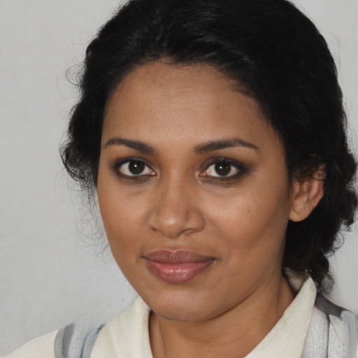 Joyful black young-adult female with medium  black hair and brown eyes