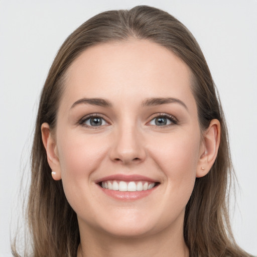 Joyful white young-adult female with long  brown hair and grey eyes