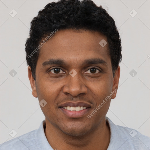 Joyful black young-adult male with short  black hair and brown eyes