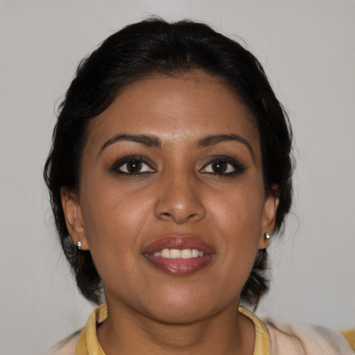 Joyful black young-adult female with medium  brown hair and brown eyes