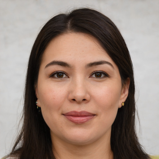 Joyful white young-adult female with long  brown hair and brown eyes