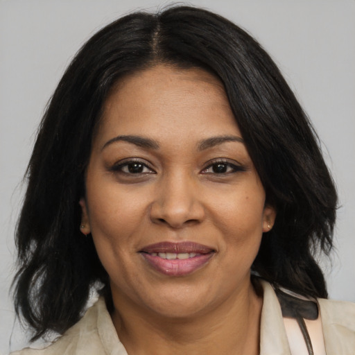 Joyful black adult female with medium  black hair and brown eyes