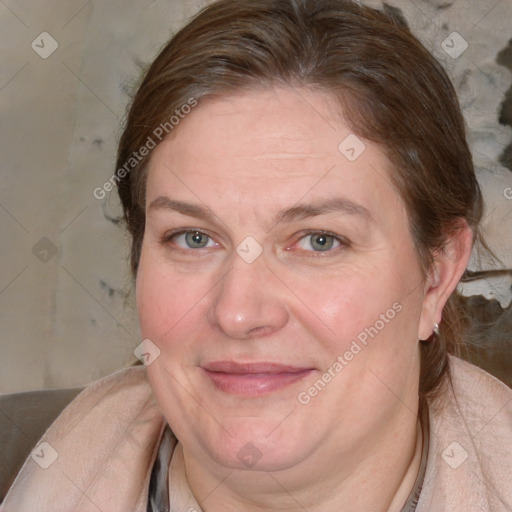 Joyful white adult female with medium  brown hair and blue eyes