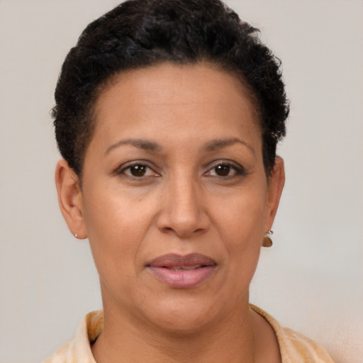 Joyful latino adult female with short  brown hair and brown eyes