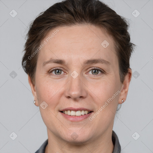 Joyful white adult female with short  brown hair and grey eyes