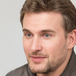 Joyful white adult male with short  brown hair and grey eyes