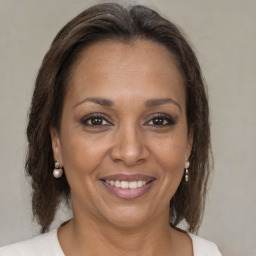 Joyful black adult female with medium  brown hair and brown eyes