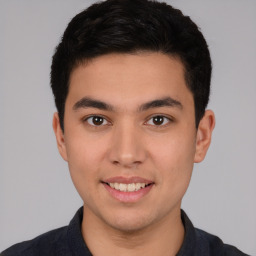 Joyful white young-adult male with short  black hair and brown eyes