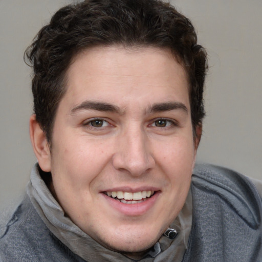 Joyful white young-adult male with medium  brown hair and brown eyes