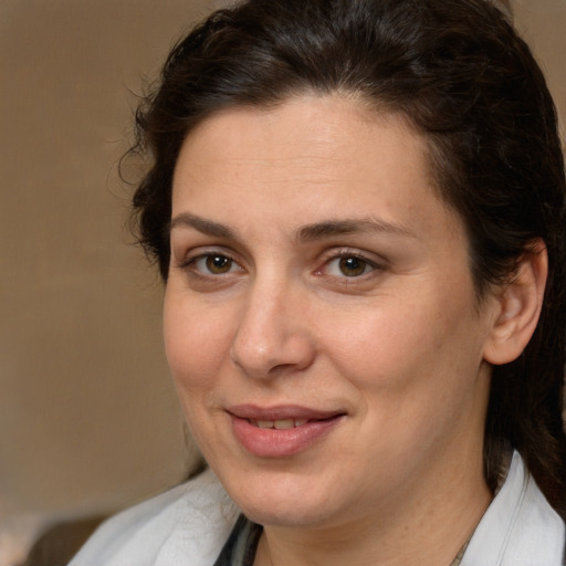 Joyful white adult female with medium  brown hair and brown eyes