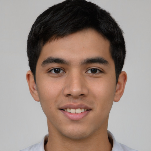 Joyful asian young-adult male with short  black hair and brown eyes