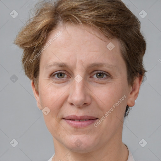 Joyful white adult female with short  brown hair and grey eyes