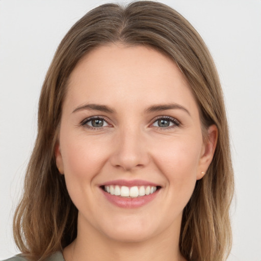 Joyful white young-adult female with medium  brown hair and grey eyes