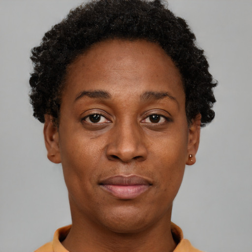 Joyful black young-adult female with short  brown hair and brown eyes