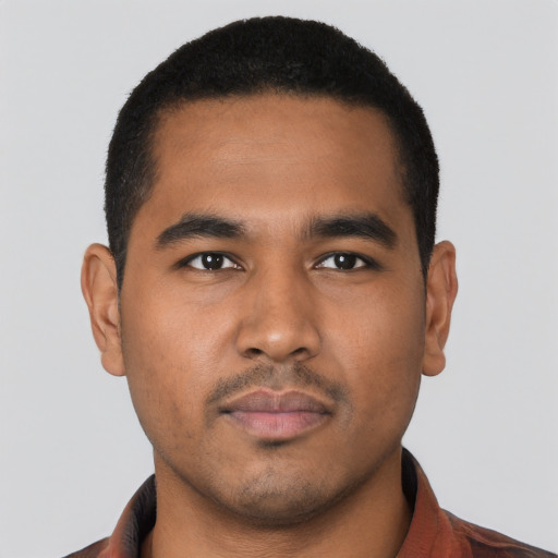 Neutral latino young-adult male with short  black hair and brown eyes