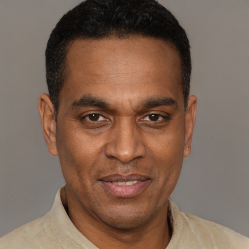 Joyful latino adult male with short  brown hair and brown eyes