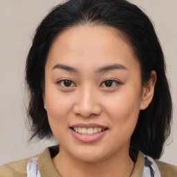 Joyful asian young-adult female with medium  brown hair and brown eyes