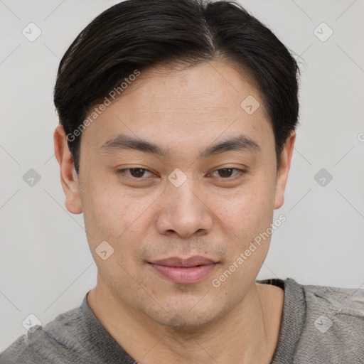 Joyful asian young-adult male with short  brown hair and brown eyes