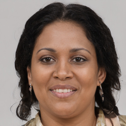 Joyful black adult female with medium  brown hair and brown eyes