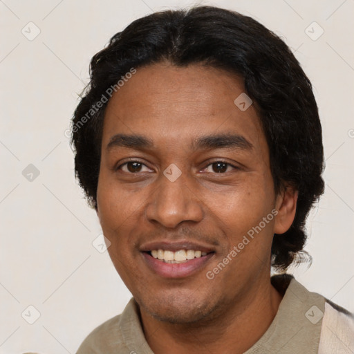 Joyful latino adult male with short  black hair and brown eyes