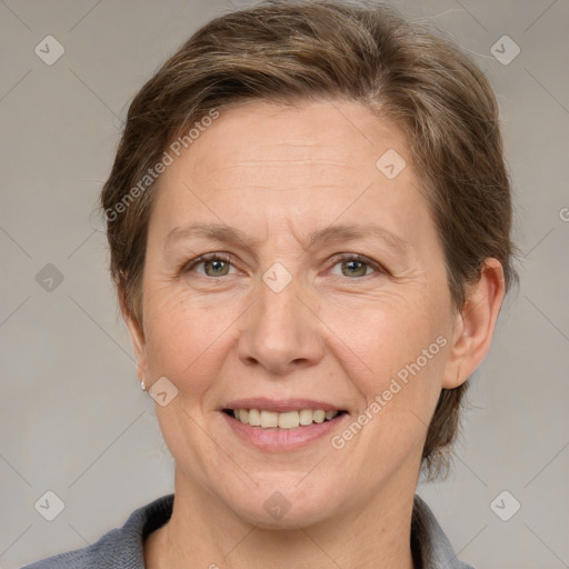 Joyful white adult female with medium  brown hair and grey eyes