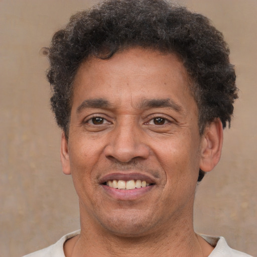 Joyful latino adult male with short  brown hair and brown eyes
